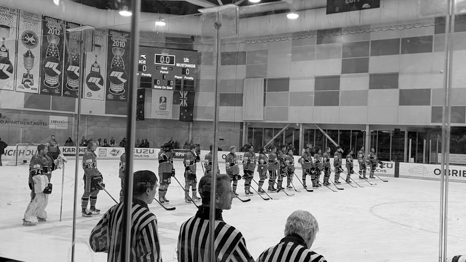 The Melbourne Mustangs starting lineup for their Good Friday Appeal game. A black and white filter has been applied.
